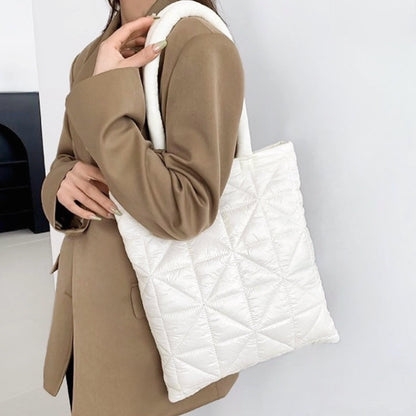 Model carrying a white polyester shoulder bag, great for daily carry and travel.