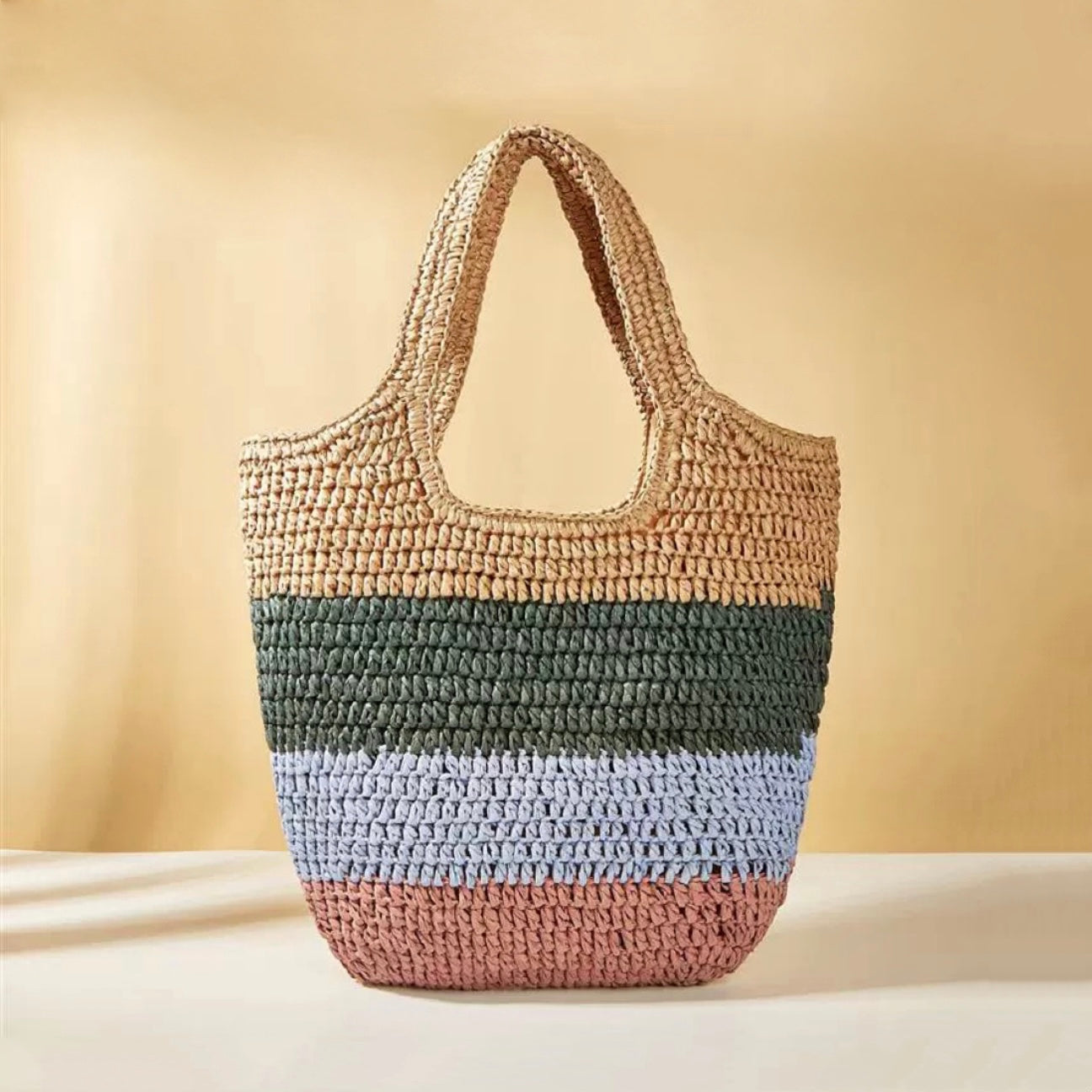 Stripe Rattan Straw Bag with horizontal stripes in natural, green, light blue, and pink.