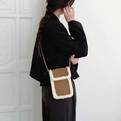 Model carrying a brown Suede Crossbody Bag With Plush Trim as crossbody, ideal for city walks and gifting.