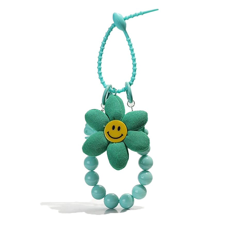Flat lay of Sunny Bloom Bag Charm in green, great for everyday styling and gifting.