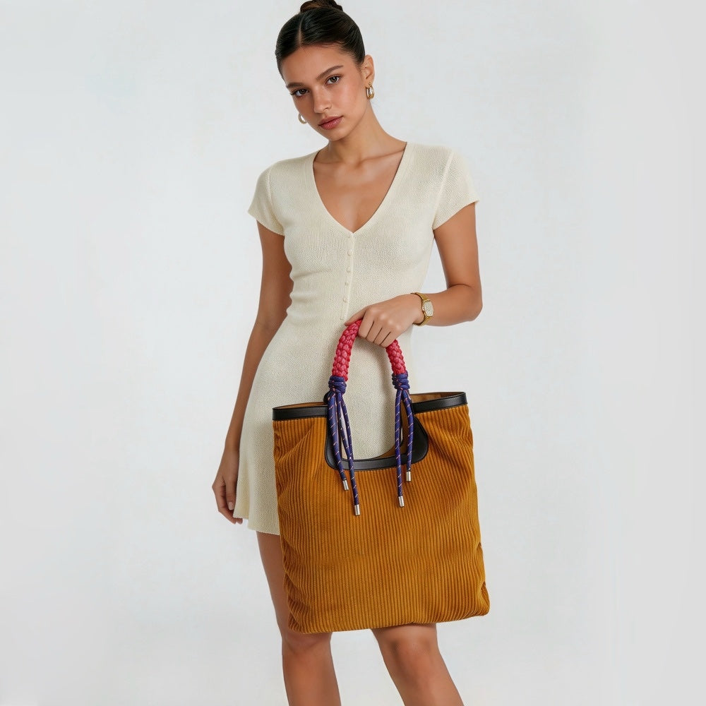 Model carrying the large capacity corduroy tote bag, showcasing an elegant casual style.