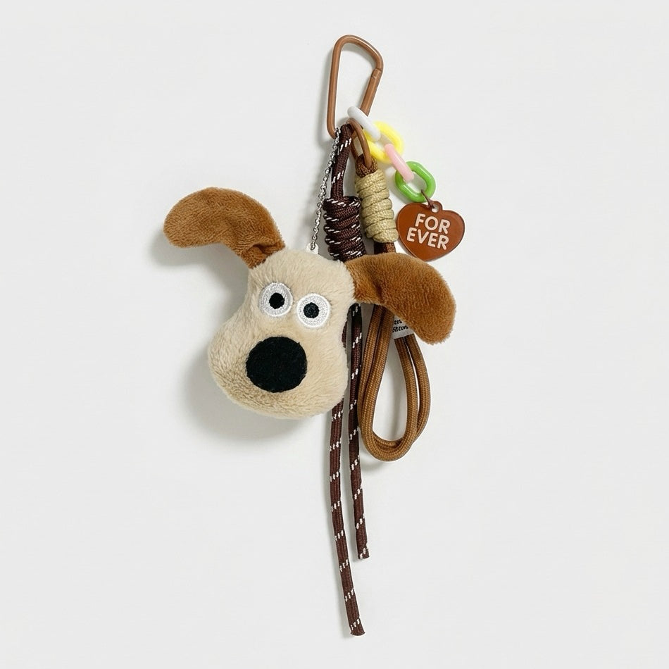 Close-up of the Super Dog bag charm with carabiner, ropes and heart tag.