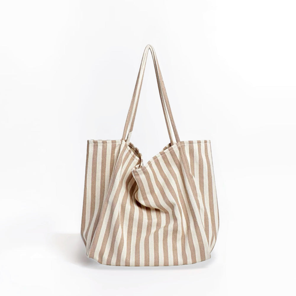 Front view of khaki and white striped canvas tote, minimalist aesthetic ideal for summer vacations.
