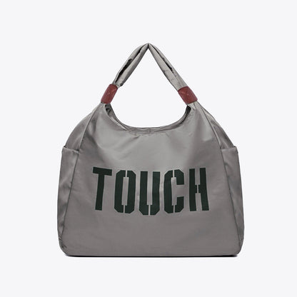Flat lay of Touch Nylon Weekend Bag in gray, easy for commuting and weekends.