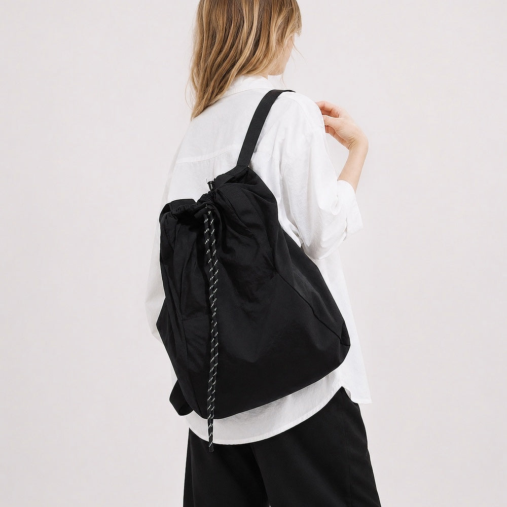 Model styled with the purple ultralight 2-way convertible nylon backpack.