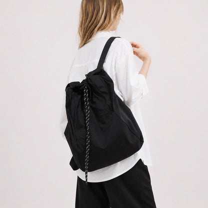 Model styled with the purple ultralight 2-way convertible nylon backpack.