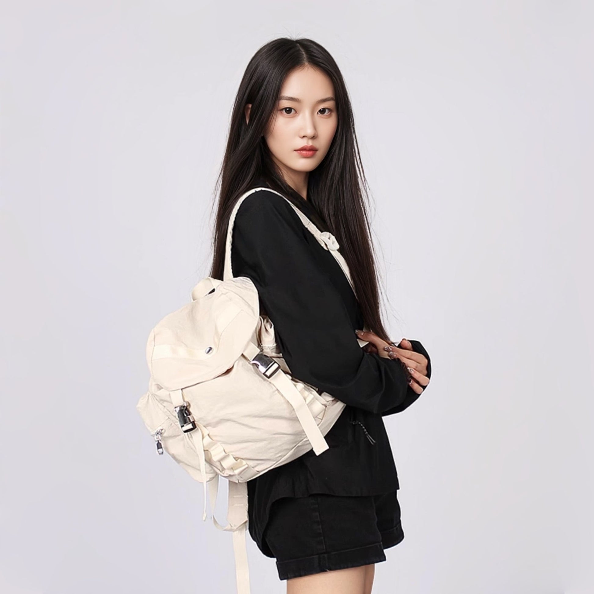 Model carrying a beige polyester backbag on the shoulder, easy for commuting and weekends.