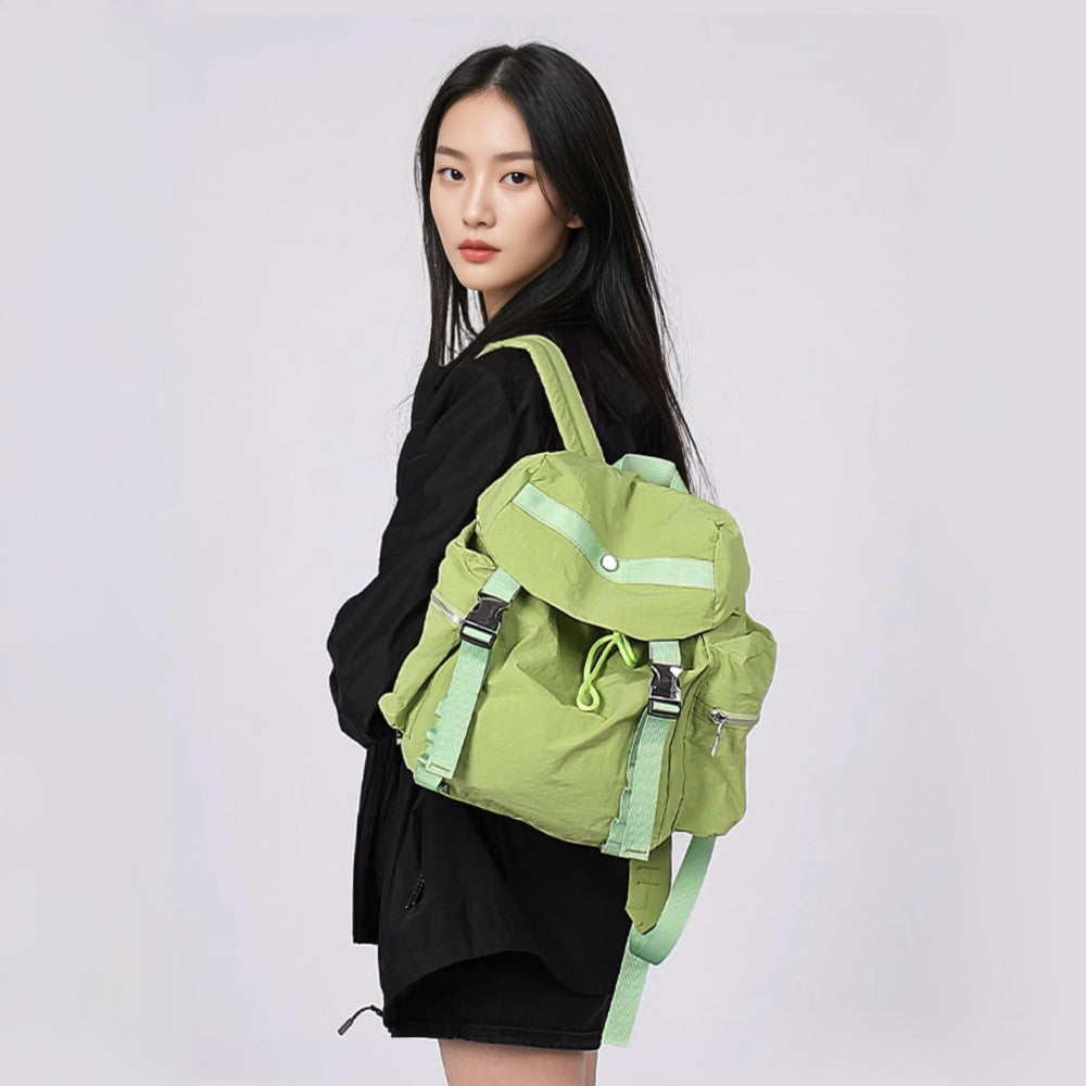 Model carrying a green Ultralight Urban Daily Backpack, functional street style accessory.