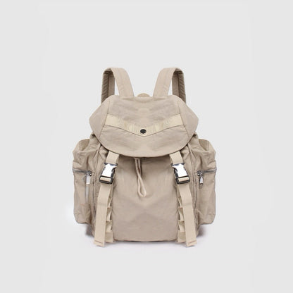 Angled view of khaki polyester ultralight urban daily backpack with flap top, dual buckles, drawstring, and side zip.