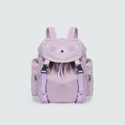 Angled view of Ultralight Urban Daily Backpack  in purple, showing compact width and flap design.