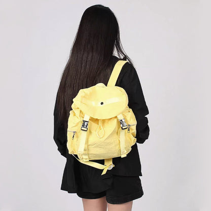 Model carrying a yellow  Ultralight Urban Daily Backpack, bright fashion lifestyle view.