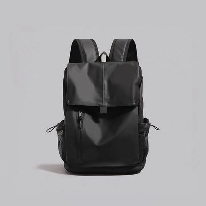 Front view of the black water-resistant Oxford flap backpack with front zip pocket.