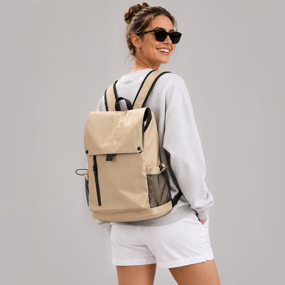 Back view of a model carrying the khaki flap laptop backpack.