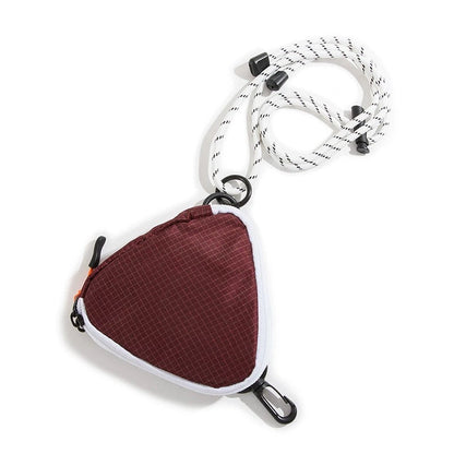 Studio product view of the maroon and white color-block triangle nylon pouch with its white and black speckled utility cord.