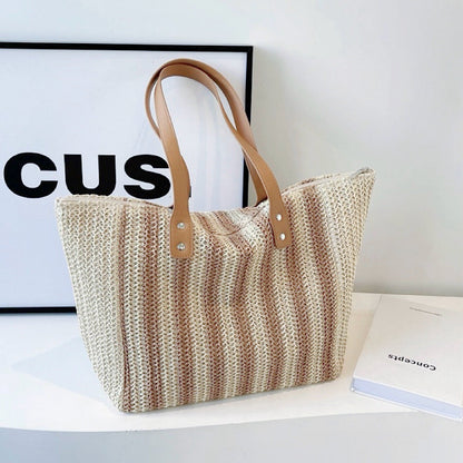 Folded view of Vertical Striped Straw Tote Bag in khaki, easy for commuting and weekends.