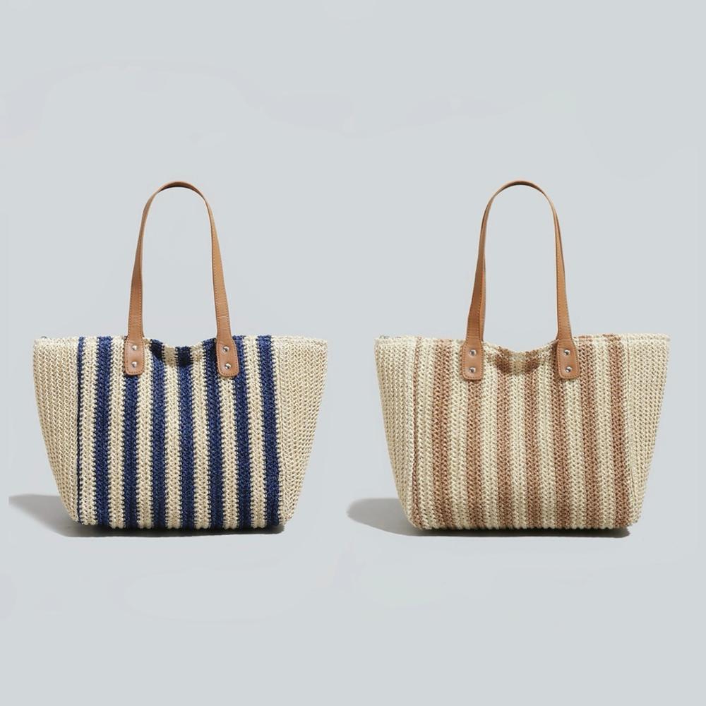 Two vertical striped straw tote bags with PU leather straps; one blue and natural, one brown and natural. 
