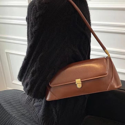 Model carring a brown vintage baguette shoulder bag, ideal for errands.