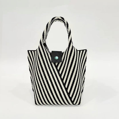 Angled view of Vintage striped knitted handbag in black.