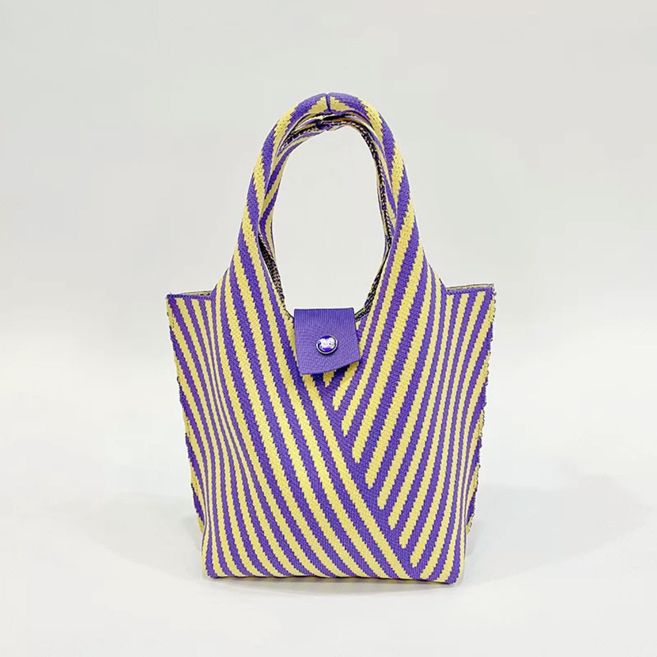 Flat lay of Vintage Striped Knitted Handbag in yellow, great for everyday carry and travel.