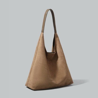 Side profile of the camel vintage suede hobo bag showcasing its slouchy shape.