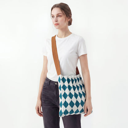 Model styling a Viridian-White argyle pleated knit bag for a chic style.
