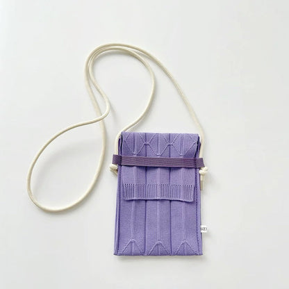 Angled view of Vivid Knit Pleat Mini Bag in purple, ideal for errands and gifting.