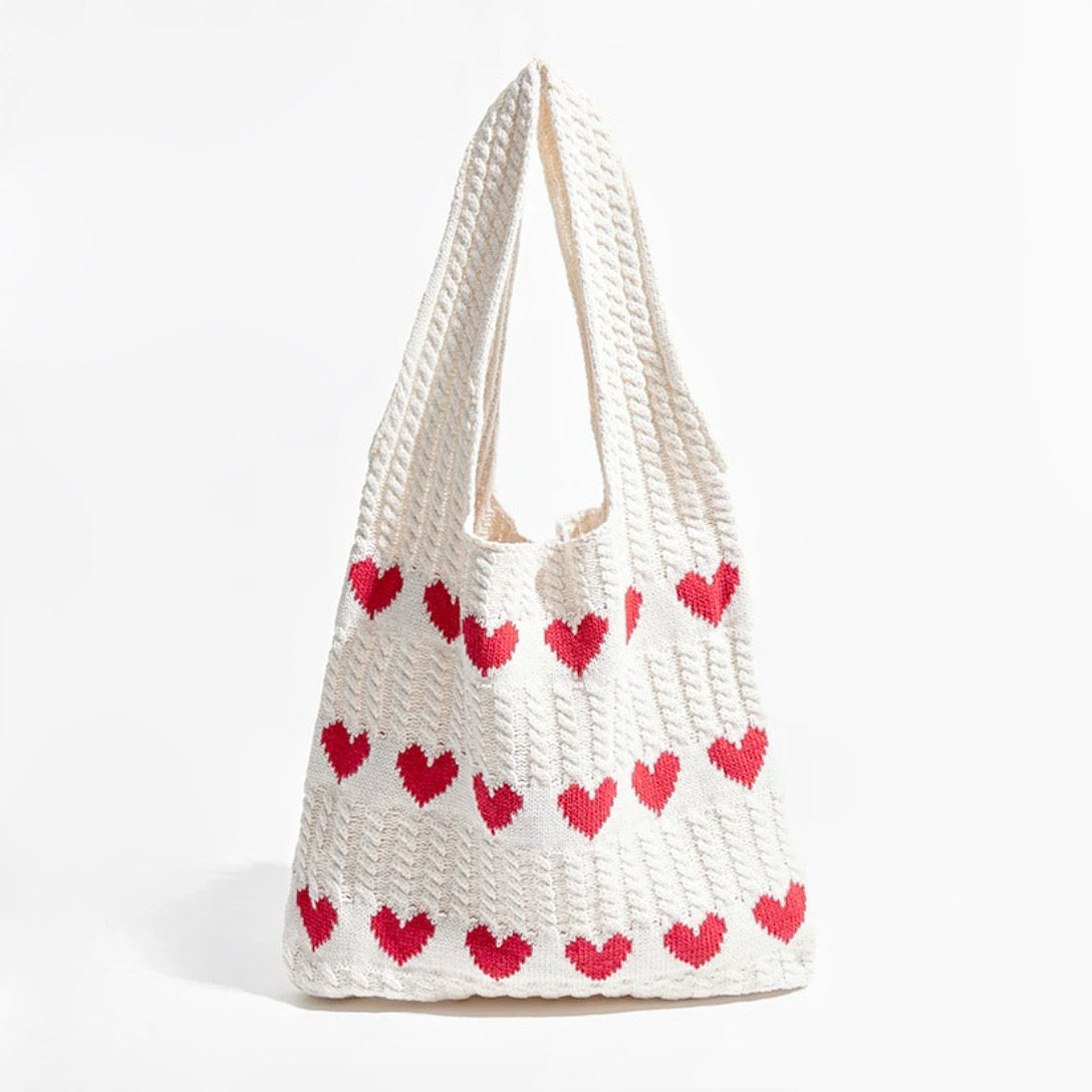Front view of the white heart crochet bag showing the heart pattern and texture.