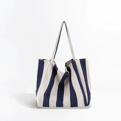 Folded view of Wide Stripe Canvas Tote Bag in navy blue, easy for commuting and weekends.