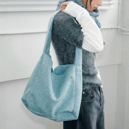 Model carrying a blue Woolish Cozy Tote Bag on the shoulder, great for daily carry and travel.