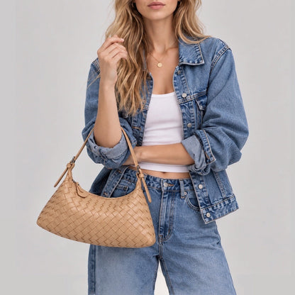 Model wearing a warm camel tan woven crossbody purse with a denim jacket outfit.