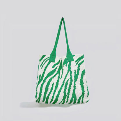 Flat lay of Zebra Print Knitted Tote Bag in white and green, great for everyday carry and travel.