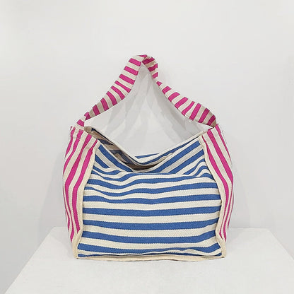 Folded view of Zesty Stripe Canvas Tote Bag in blue, easy for commuting and weekends.