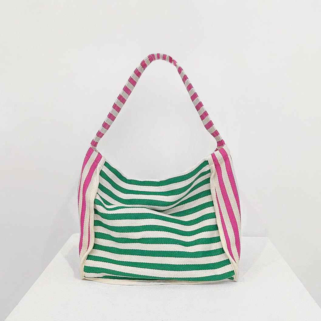 Front view of Zesty Stripe Canvas Tote Bag with green and white horizontal stripes, pink and white striped handles.