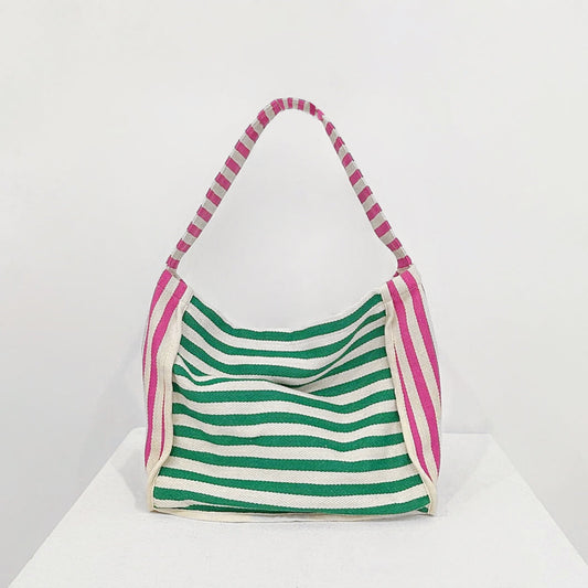 Front view of Zesty Stripe Canvas Tote Bag with green and white horizontal stripes, pink and white striped handles.